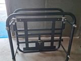 a black metal chair that is sitting in a garage