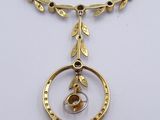a close up of a necklace on a white surface