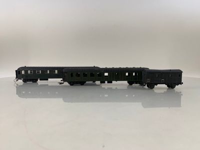 the toy train is sitting on the table on the white surface