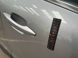 a sticker on the door of a car that has a ruler attached to it
