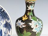 two vases sitting next to each other on a table