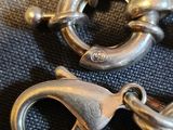 two pairs of silver metal rings on a blue cloth