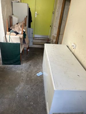 an image of a room that has a refrigerator and a refrigerator freezer in it