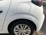 a small white car parked in a parking lot