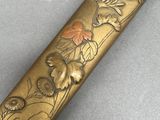 an image of a close up of a metal object with flowers on it