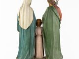 three figurines of jesus, mary, and a child in green robes