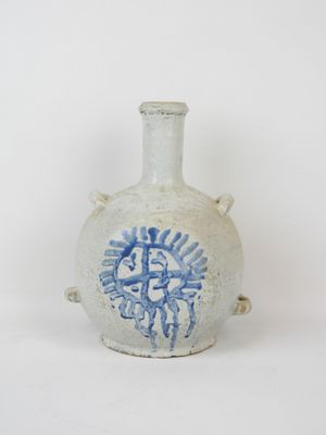 a white vase with a blue design on it