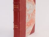 a red book that is sitting on a white surface