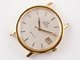 a gold watch with a white face on a white surface