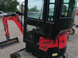 an image of a small excavator parked in a parking lot