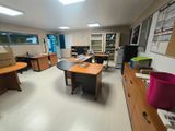 a room with a lot of desks and chairs in it