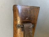 a close up of a wooden object with a leather strap