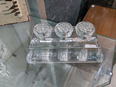 une table en verre sur laquelle sont posés quatre bocaux en verre