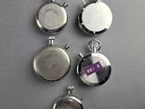 four silver lockes with a purple tag on them sitting on a table