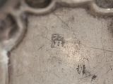 a close up view of a silver plate with holes in it