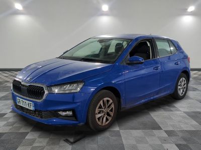 a blue car parked in a room with a checkered floor
