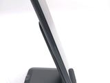 a cell phone on a stand on a white surface