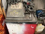 a machine that is sitting in a garage with other items