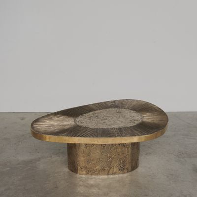 une table ovale en bois avec un piètement en métal, dans une pièce