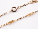 a close up of a gold chain on a white background