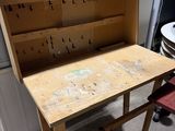 a wooden workbench with a drawer on top of it
