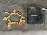 bracelet orné de breloques rouges et dorées, accompagné d'une pochette en velours noir