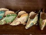 cinq paires de chaussures alignées sur une étagère