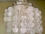 a chandelier made out of plastic bottles hanging from the ceiling
