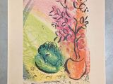 a drawing of a frog sitting on a table next to a vase of flowers
