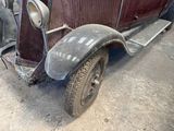 a old car that is sitting in the garage