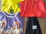 three soccer jerseys and a pair of shorts on a cardboard box