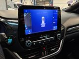 the dashboard of a car with a cell phone in the center of it