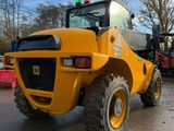 a yellow construction vehicle that is parked in the parking lot