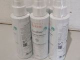 four bottles of lotion sitting on a counter