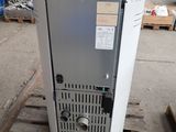 a refrigerator that is sitting on a pallet in a warehouse
