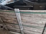 several pieces of wood are stacked together in a warehouse