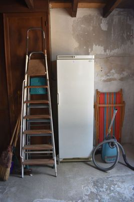 an image of a room with a ladder and a refrigerator