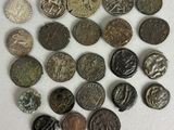 a close up of a pile of old coins on a white surface