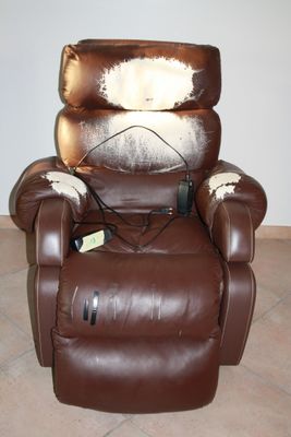a brown recliner with a cow hider on it