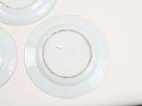 three plates on the table that have been painted white