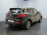 the rear view of a grey car in a showroom