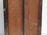 an old wooden cabinet with two doors on it