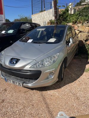 a silver car parked in a parking lot next to a black car