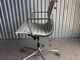 an image of an office chair in front of a corrugated wall
