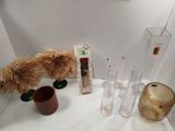 a table with vases and vases on it and a clock on the wall