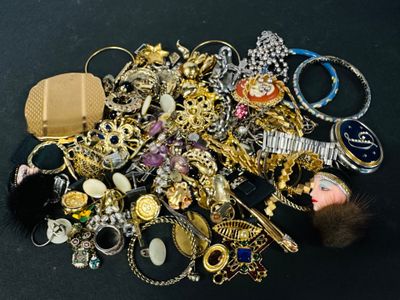 a pile of assorted jewelry on a black surface