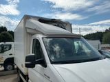 a white truck with a camper on top parked in a parking lot