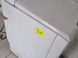 a small white refrigerator in the corner of a room