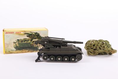 a small toy tank next to a box of marijuana