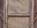 an old wooden picture frame with a rope hanging from it ' s side